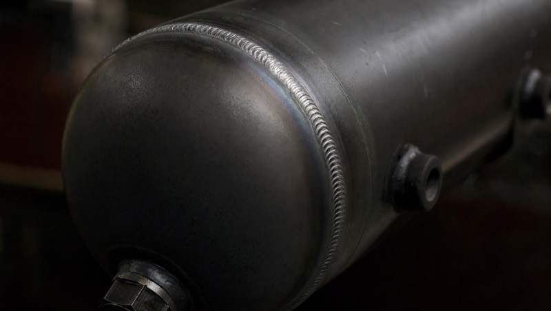 Close-up of a circumferential weld seam on a steel air reservoir